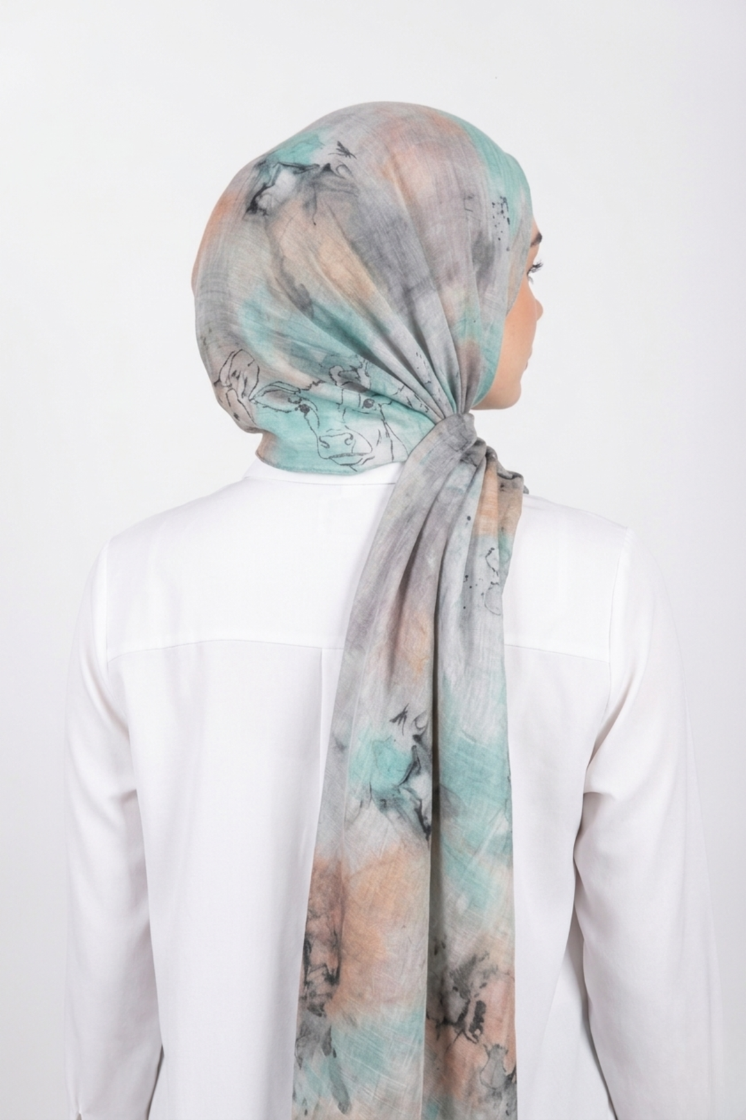 Person wearing a floral headscarf on a white background