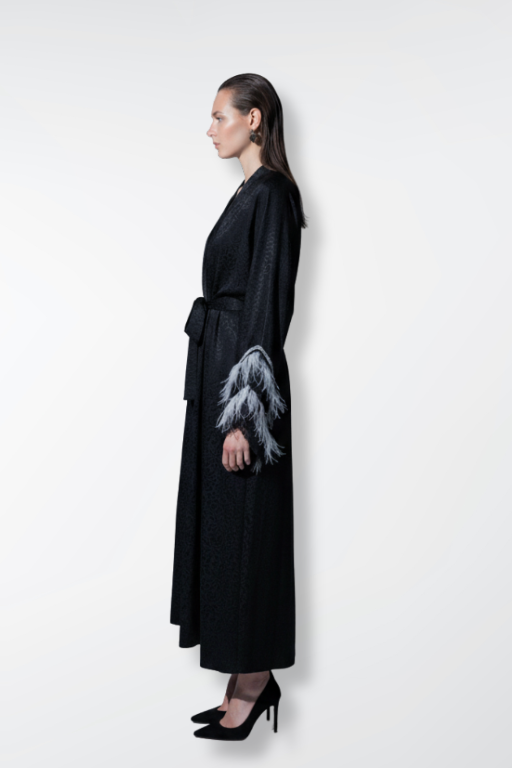 Woman wearing a black robe with a white design on a white background