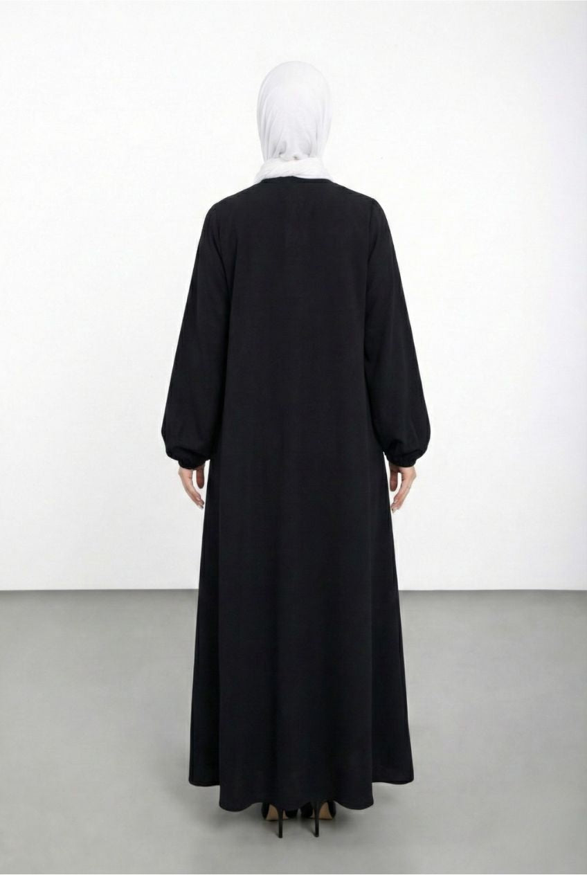 Black abaya worn by a mannequin on a white background