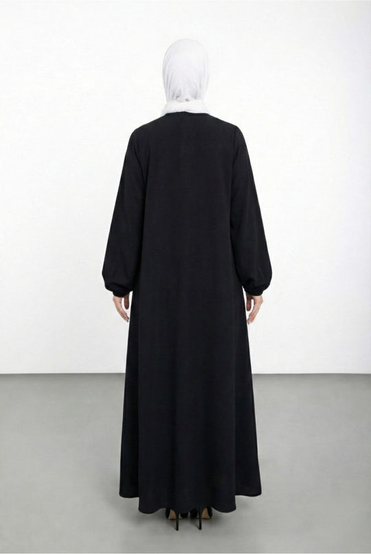 Black abaya worn by a mannequin on a white background