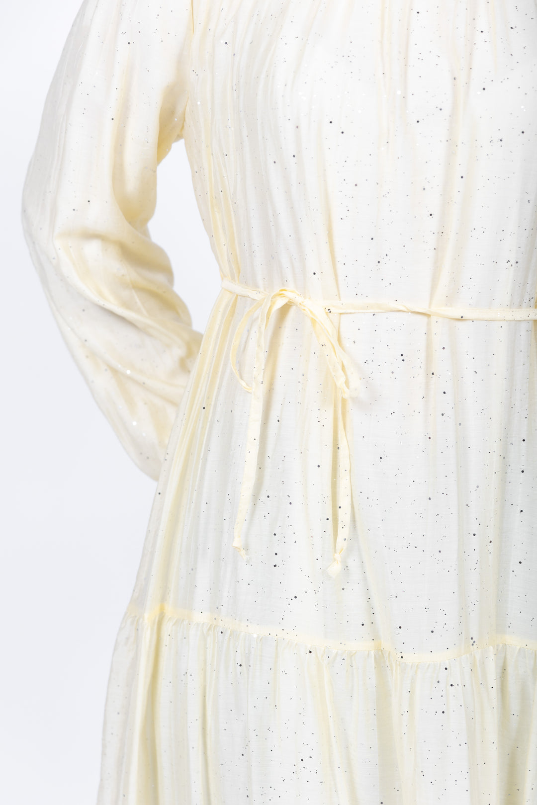 Close-up of a white dress with thin straps on a light background