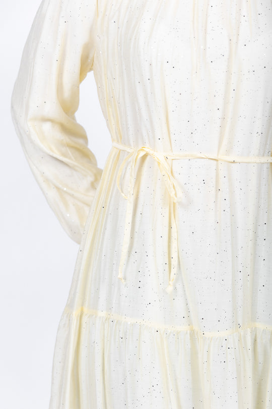 Close-up of a white dress with thin straps on a light background