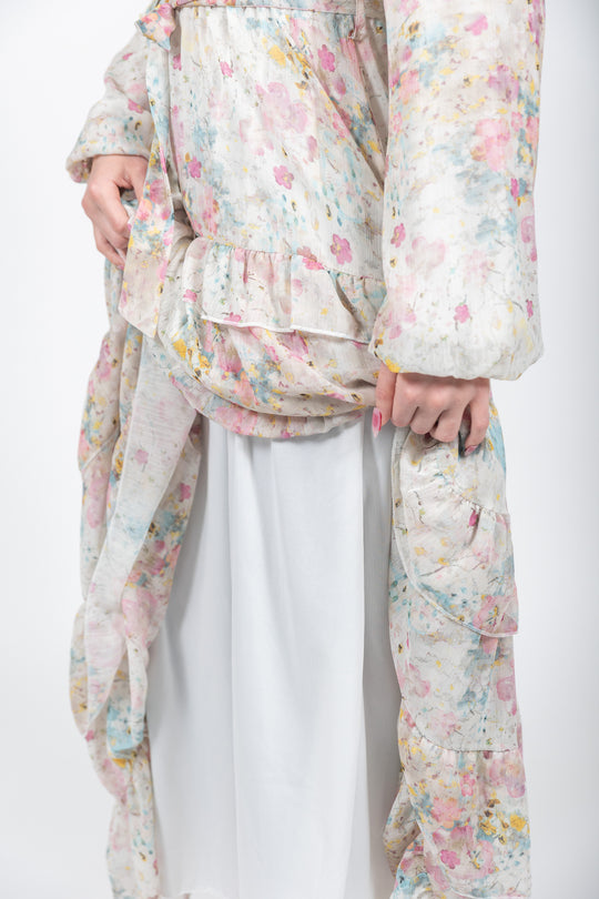 Person wearing a floral kimono over a plain outfit on a white background