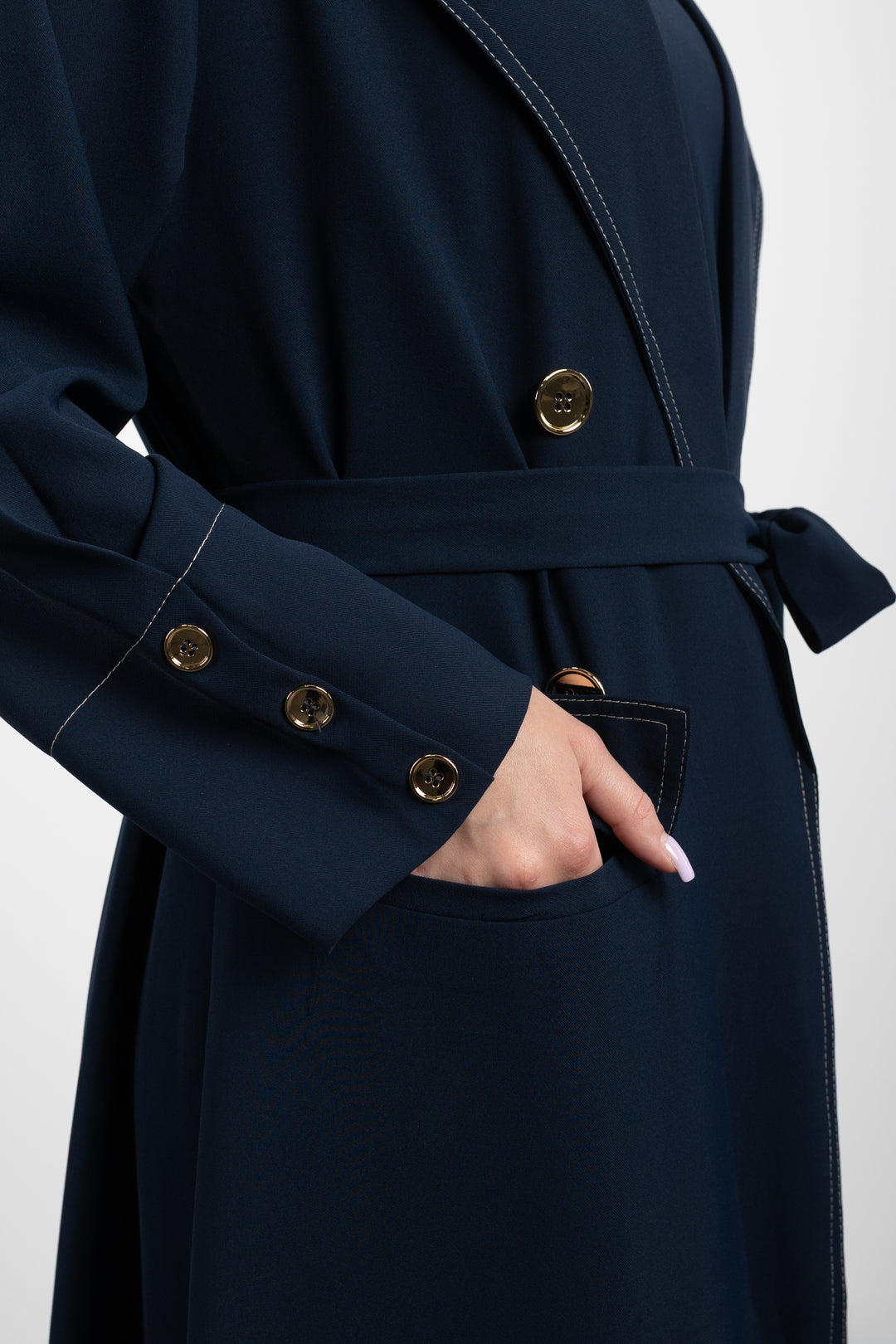 Navy blue coat with gold buttons on a white background