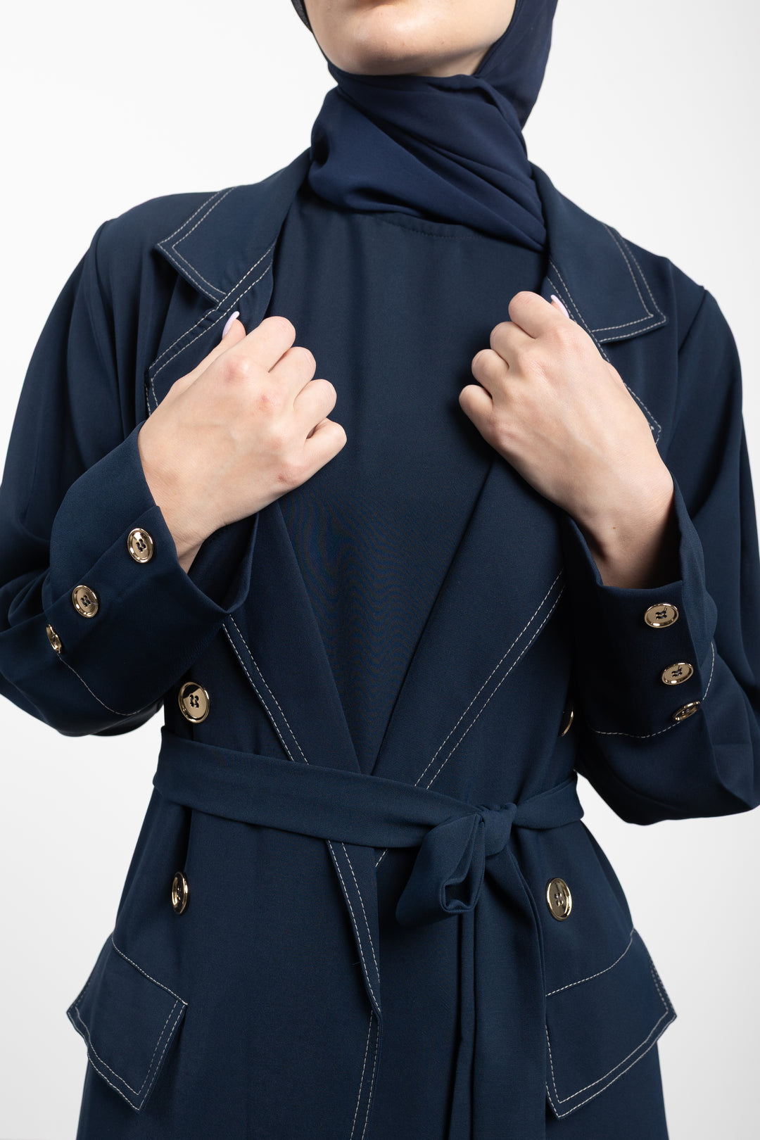 Navy blue coat with gold buttons on a white background